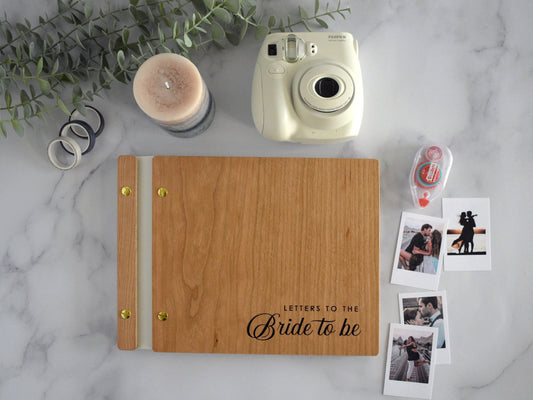 Engraved letters to the bride wooden wedding guest book in an cherry finish with customized couples names and minimalist design engraving.