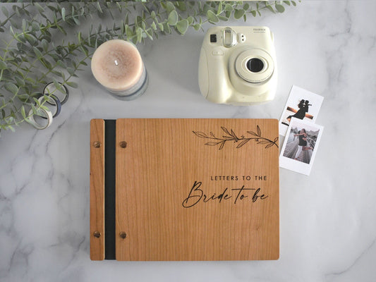 Engraved letters to the bride wooden wedding guest book in an cherry finish with customized couples names and minimalist design engraving.