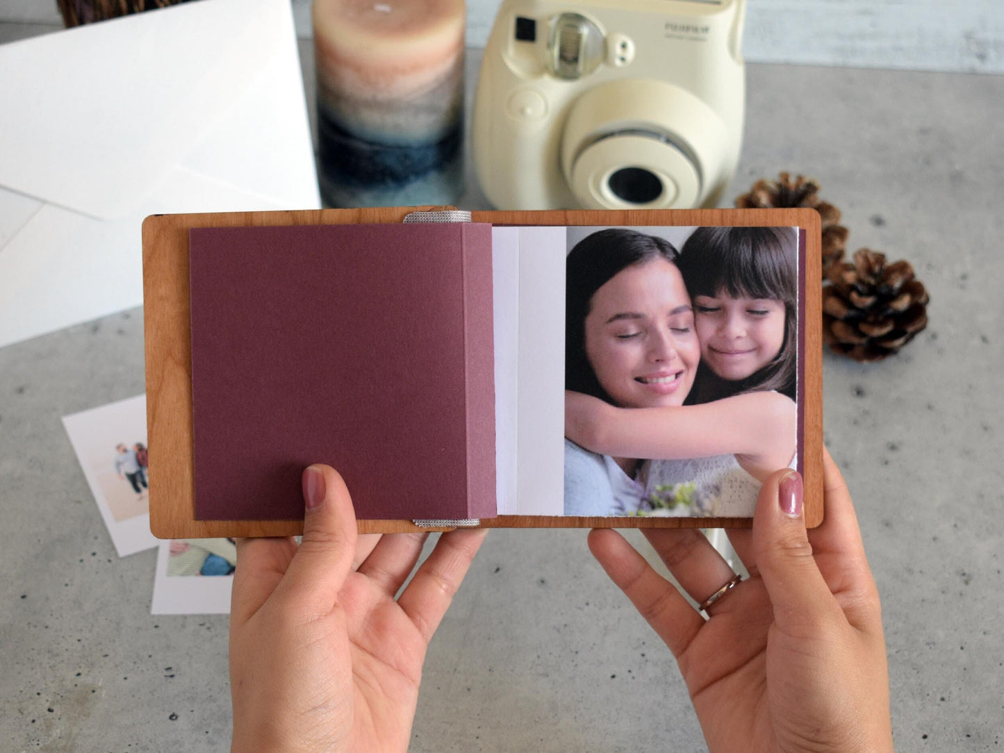 Mini wooden photo book for Moms treasured Polaroids, engraved with The Best MOM - perfect for Mothers Day 2024 keepsakes.