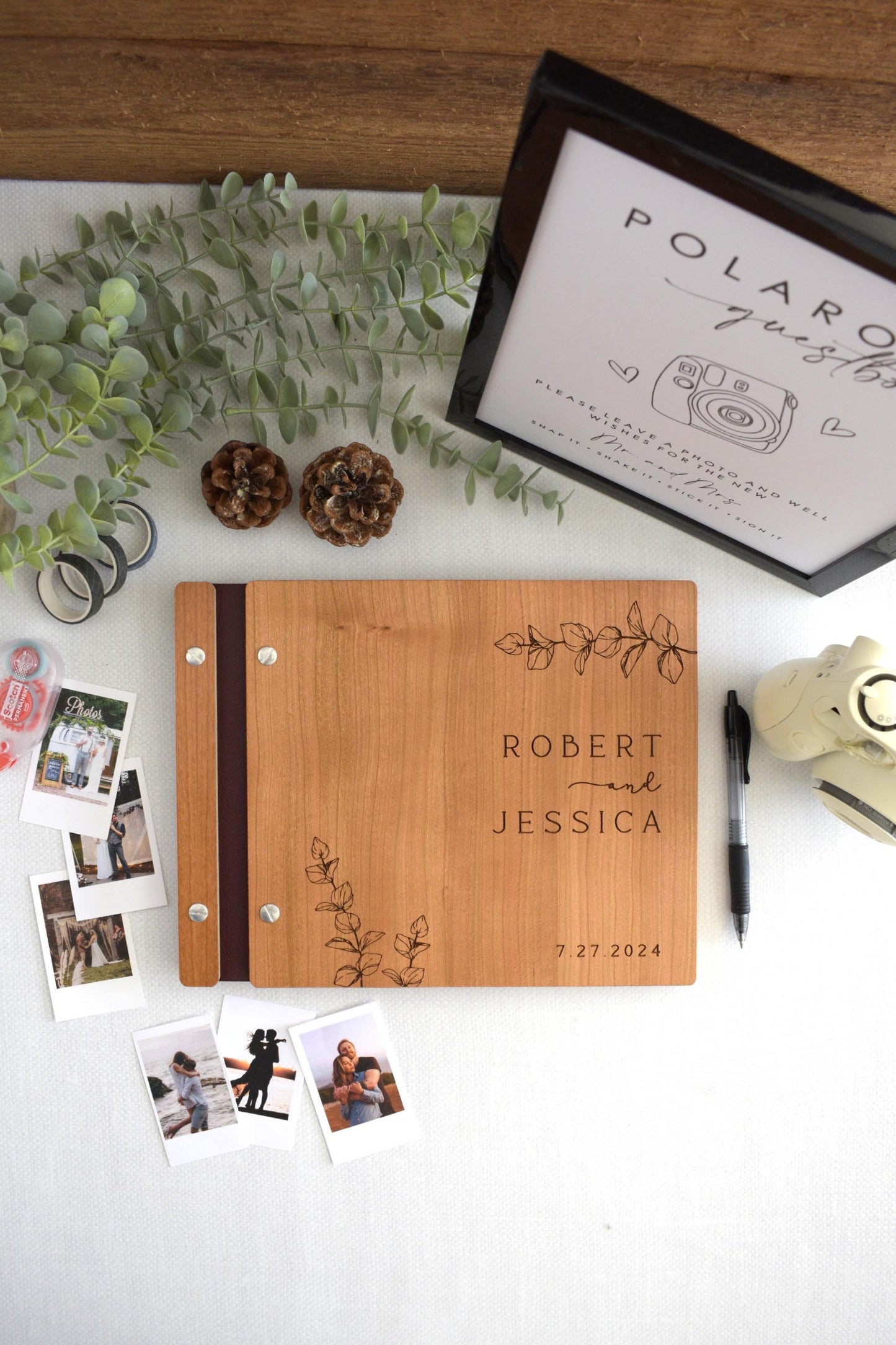 Custom wooden wedding guest book featuring elegant eucalyptus leaf engraving. Perfect for capturing special memories, this personalized guest book adds a touch of natural beauty and sophistication to your wedding or special event.