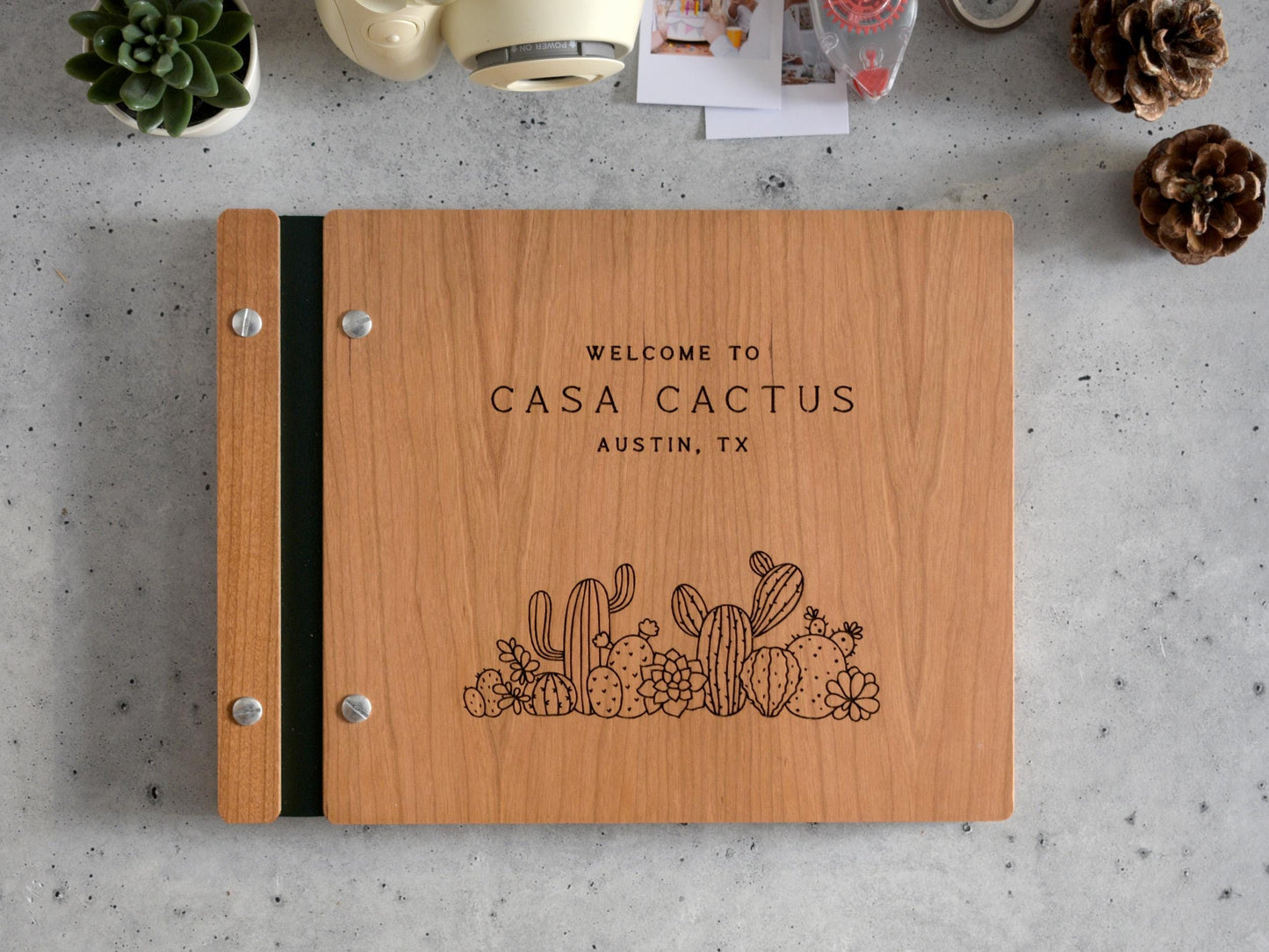 a wooden notebook with a cactus design on it