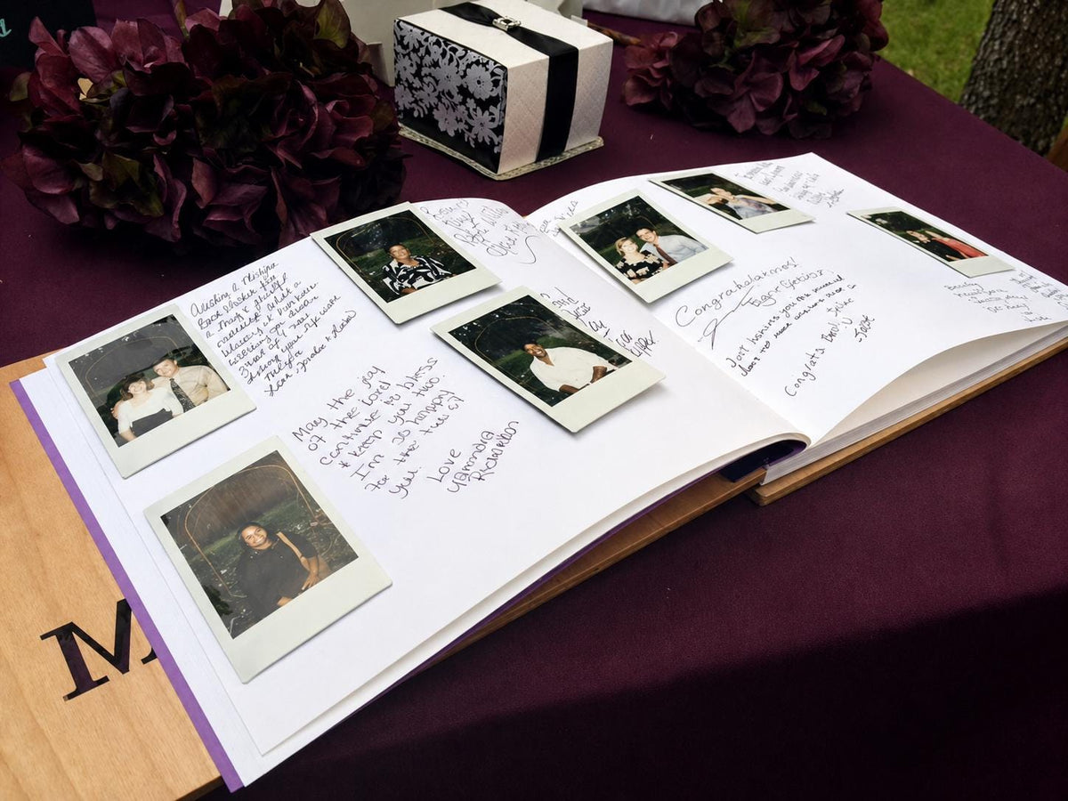 an open book with handwritten notes and several Polaroid photographs arranged on the pages.