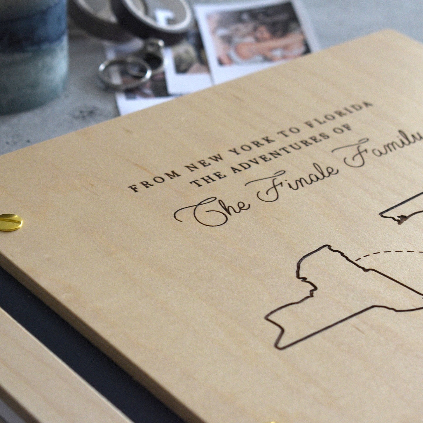 Engraved honeymoon adventure book in an Maple finish with customized couples countries or cities in a minimalist design engraving style.