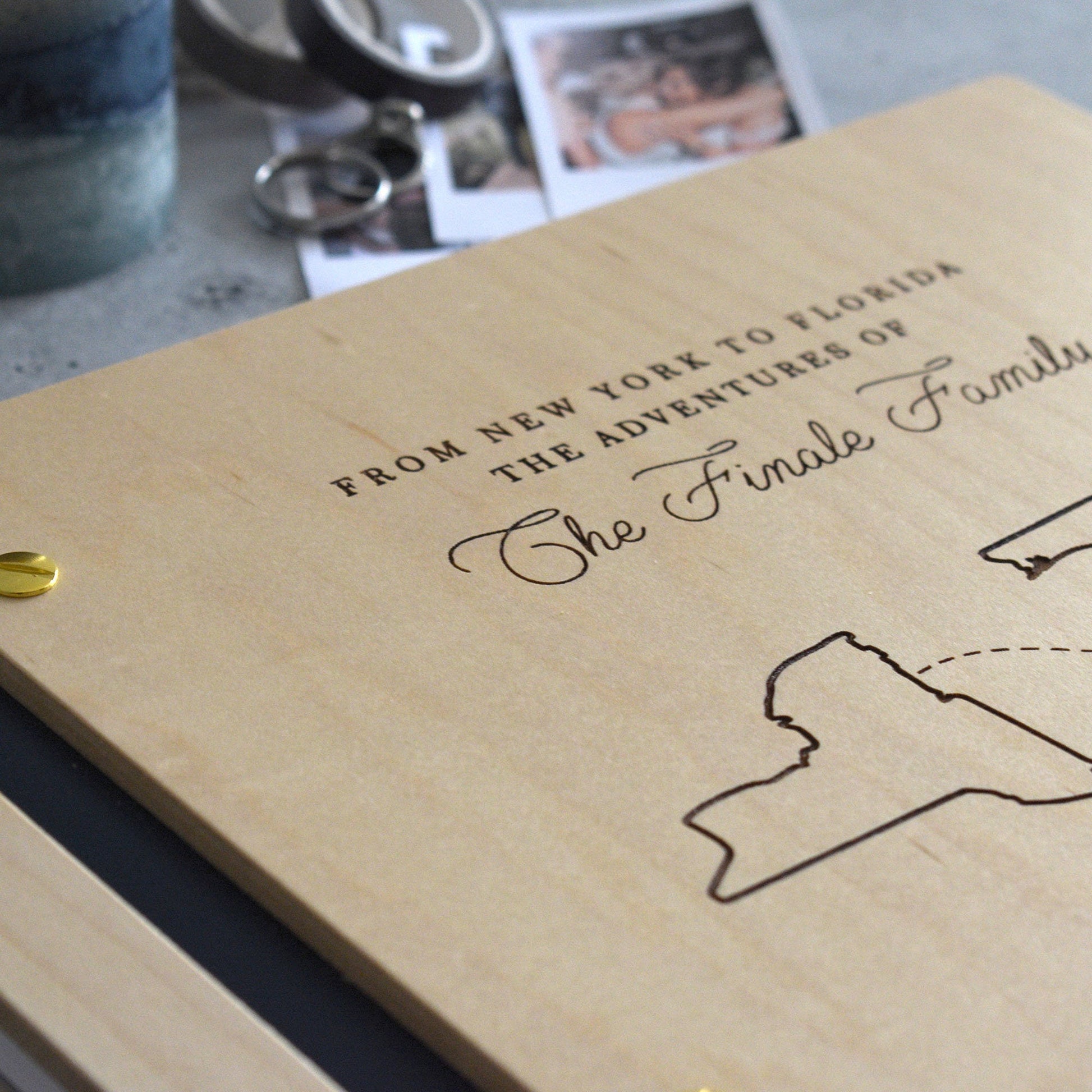 Engraved honeymoon adventure book in an Maple finish with customized couples countries or cities in a minimalist design engraving style.
