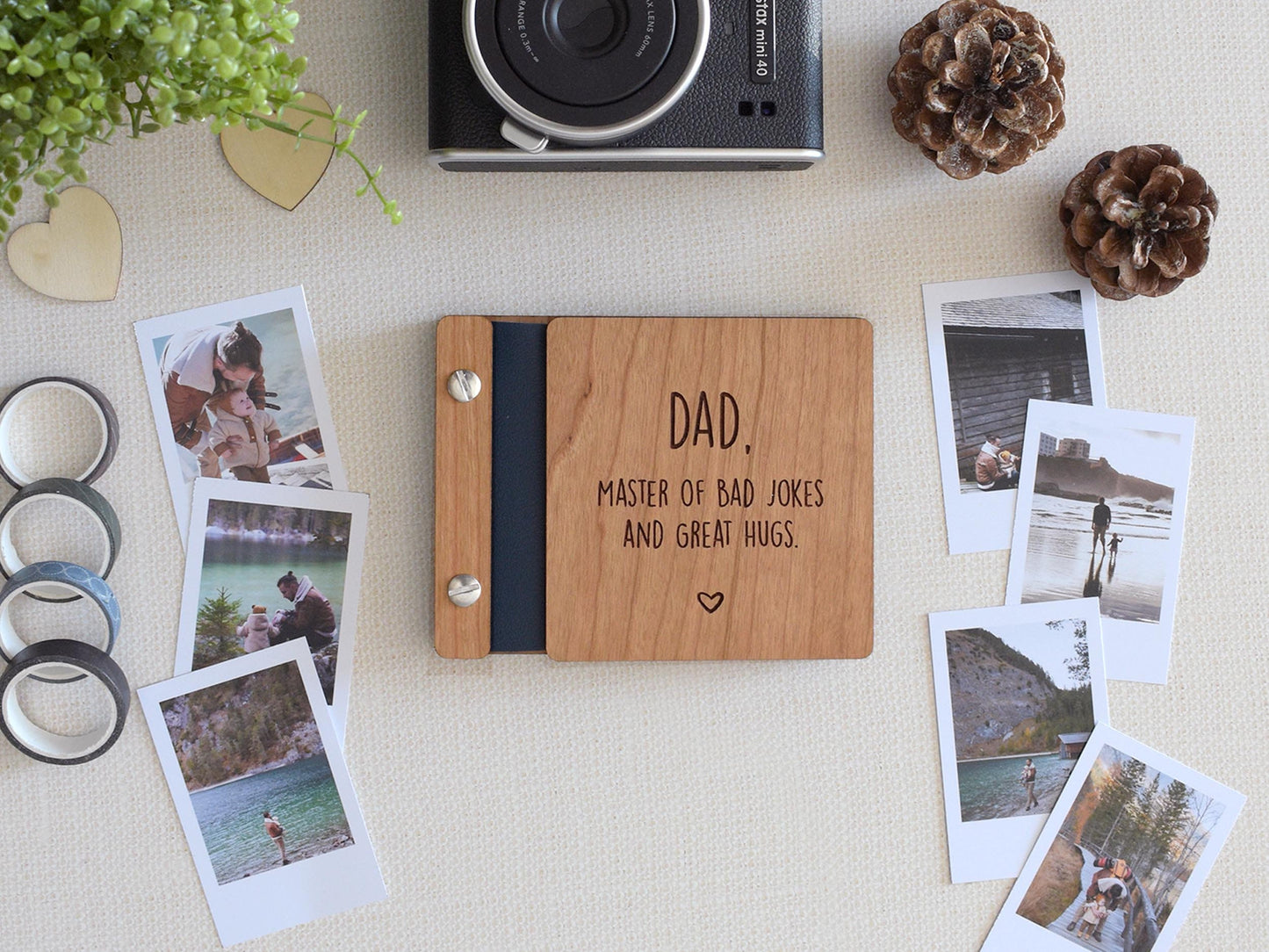 Handcrafted mini keepsake polaroid photo book with wooden cover and customizable engraving, perfect for Fathers Day. This unique gift for Dad features the message dad, master of jokes and great hugs and is an ideal Father&#39;s Day gift for him.